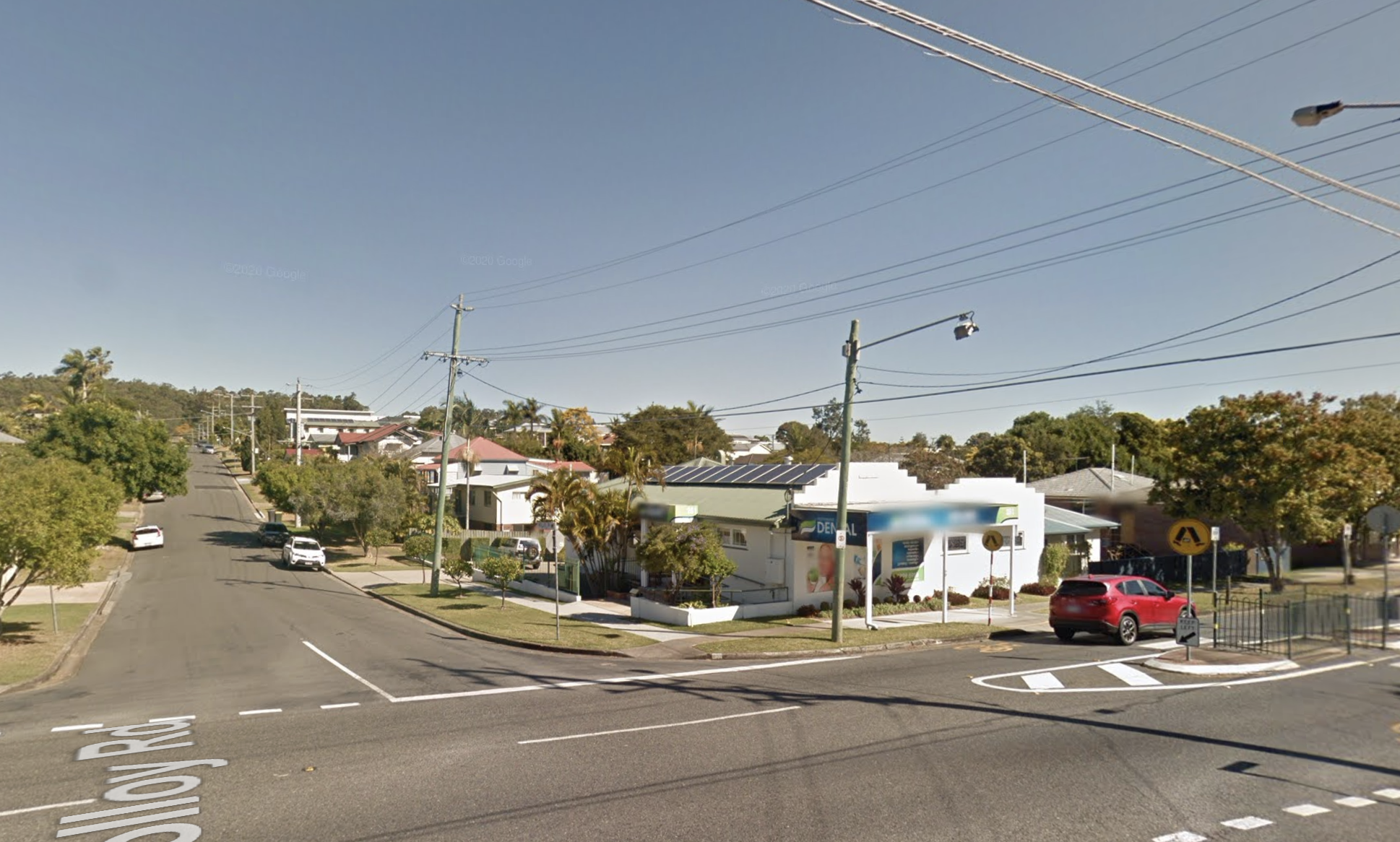 A street with palm trees, shadows pointing south, cars driving on LHS.